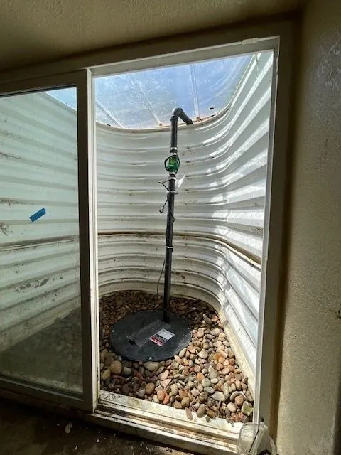 Finished sump pump installation basement window well