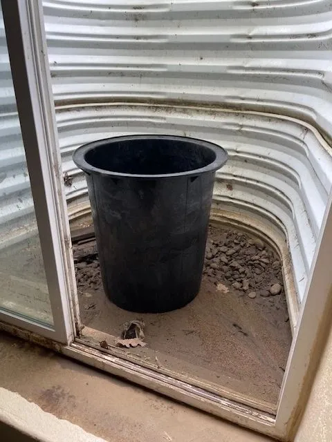 Water collecting pot in basement window well