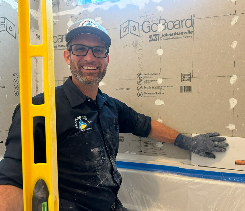 Gabriel working on finishing up a bathroom remodel
