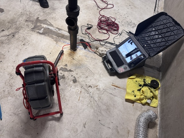 Sewer camera video pipe inspection showing drain line condition on monitor screen